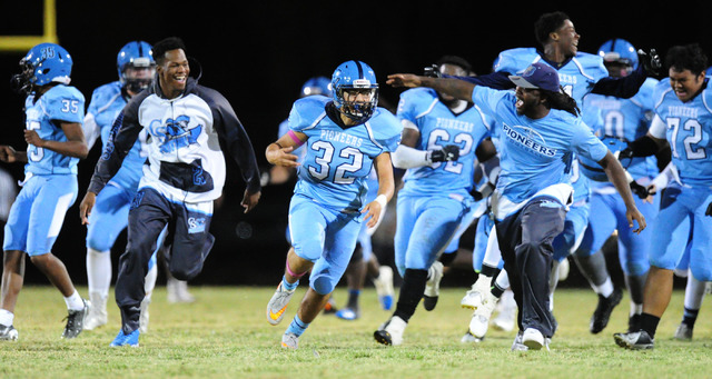 Canyon Springs players celebrate after kicker Cesar Barron-Rodriguez (32) kicked the game wi ...