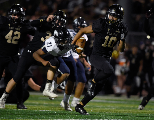 Faith Lutheran’s Taimani McKenzie (10) runs for a touchdown after recovering a fumble ...