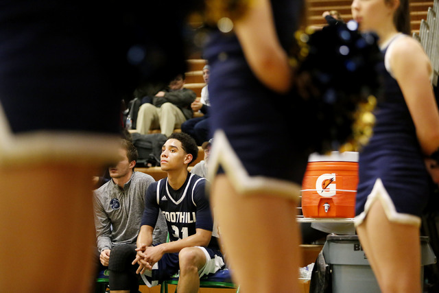 Foothill’s Marvin Coleman (31) watches his teammates play during a high school basketb ...