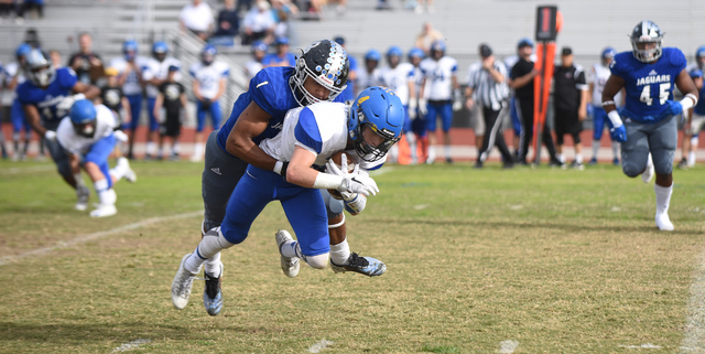 Desert Pines Tony Fields (1) tackles South Tahoe’s Dylan Gooding (4) during their 3A s ...