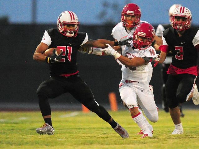 Liberty wide receiver Darion Acohido, left, fends off Arbor View safety Phenix Calinao in th ...