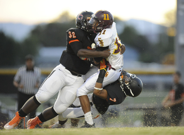 Chaparral linebacker Antwain Allen (32) and defensive back Malachi Miles (7) tackle Eldorado ...