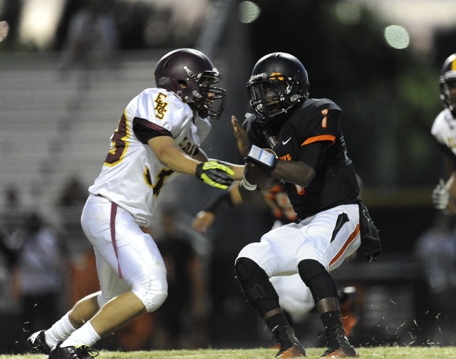 Chaparral Cowboys quarterback Jerome Williamson (1) avoids Eldorado linebacker Anthony Silva ...