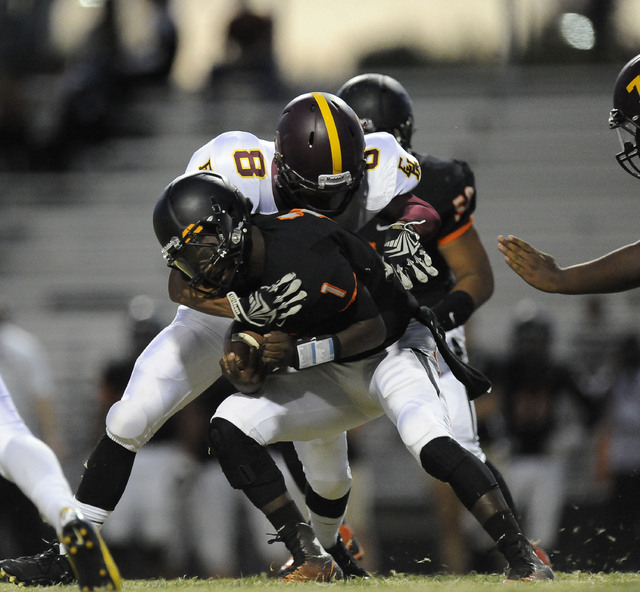 Chaparral quarterback Jerome Williamson (1) is tackled by Eldorado linebacker Marcel Hemingw ...