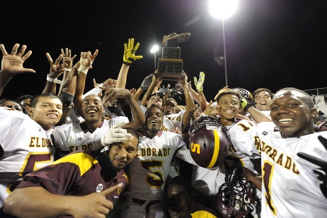 Eldorado players hoist the Cleat trophy after defeating the Chaparral Cowboys 28-21 on Frida ...