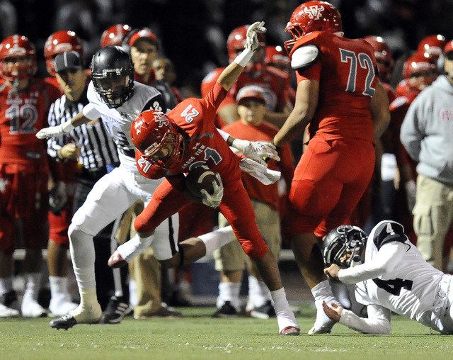 Palo Verde defensive back Devion Clayton (12) and defensive back Darrion Finn (4) trip up Ar ...