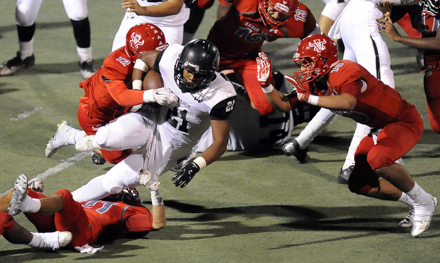 Arbor View linebacker Noah Noce (12) and defensive back Bryce Poster (15) tackle Palo Verde ...