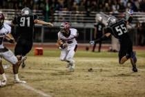 Coronado’s Nick Trejo (5) looks to elude Green Valley’s Mikey Feeney (91) and Na ...