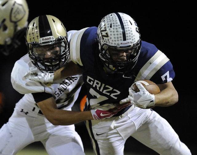 Spring Valley running back Michael Bianco (3) carries the ball while trying to fend off Fait ...