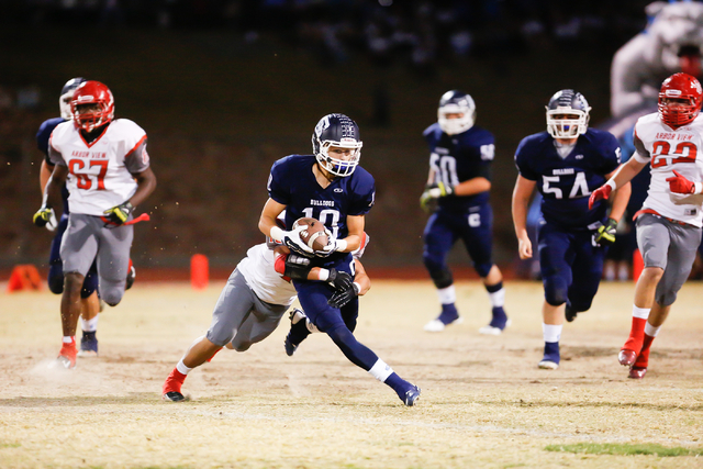 Centennial High School’s Dylan Hite (10) hangs on to the ball as Arbor View High Schoo ...