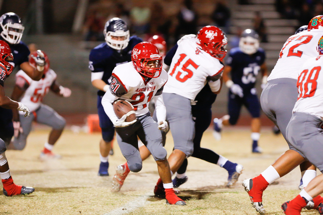 Arbor View’s Charles Louch (21) looks for running room in the first half on Thursday. ...