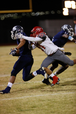 Arbor View’s Charles Louch (21) reaches out to tackle Centennial’s Joseph Cenise ...