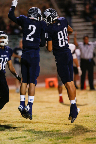 Centennial’s Brandan Harley (2) and Ivan Ochoa-Serrano (80) celebrate in the end zone ...