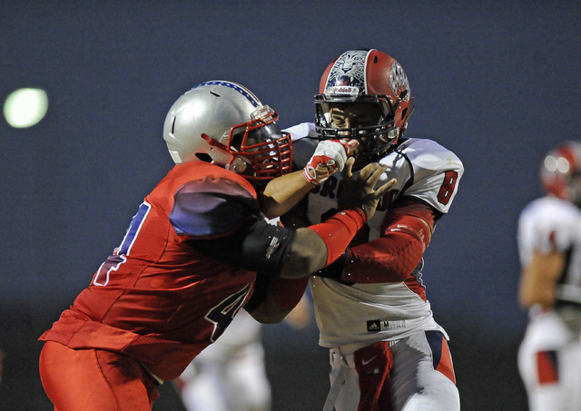 Coronado linebacker Kainoa Granstrom, right, locks up with Liberty’s Alofana Tevaseu on Se ...