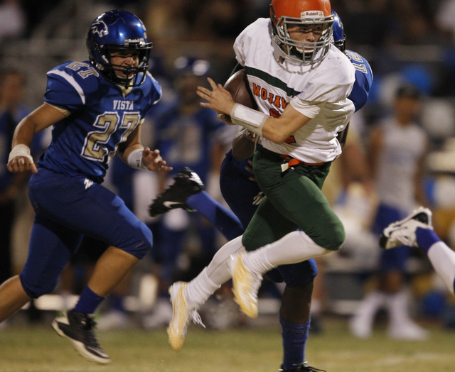 Mojave quarterback Zack Arave gets past Sierra Vista’s Quinton Stubbs left, and Randal ...