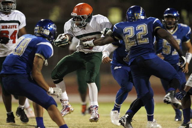 Mojave running back Ty Flanagan is grabbed by Sierra Vista linebacker Daniel Godfrey on Sept ...