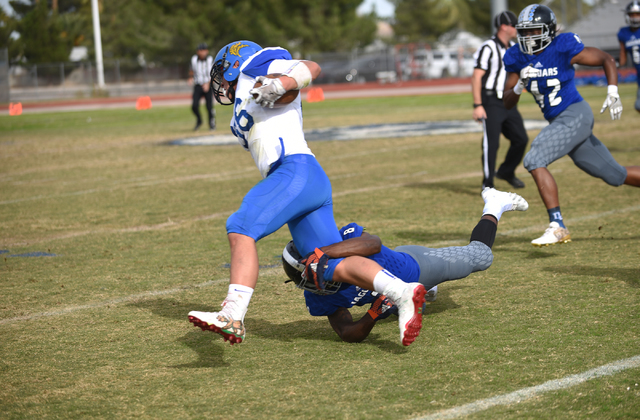 Desert Pines Andrew Gray (8) tackles South Tahoe’s Andrew Herrera (36) during their 3A ...