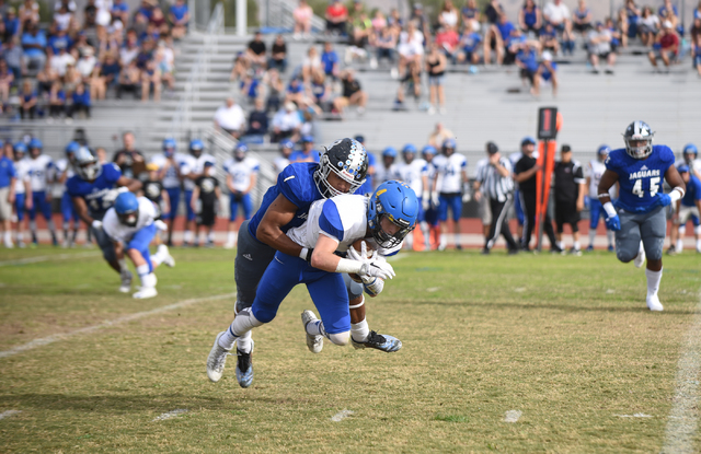 Desert Pines Tony Fields (1) tackles South Tahoe’s Dylan Gooding (4) during their 3A s ...