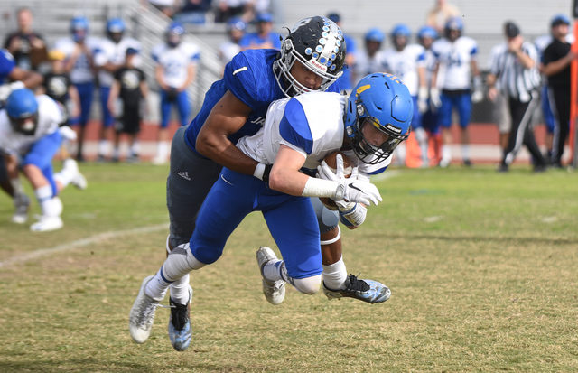 Desert Pines Tony Fields (1) tackles South Tahoe’s Dylan Gooding (4) during their 3A s ...