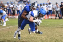 Desert Pines Tony Fields (1) tackles South Tahoe’s Dylan Gooding (4) during their 3A s ...