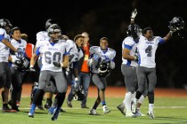 Desert Pines players celebrate their 34-27 victory over defending state champion Faith Luthe ...
