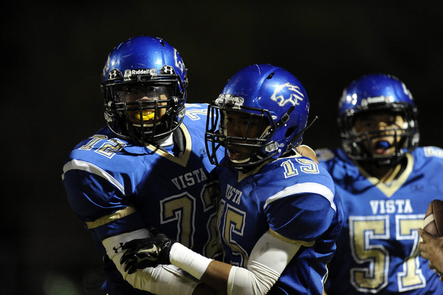 Sierra Vista running back Andrew Peterson (15) is congratulated by linebacker Austin Tufono ...