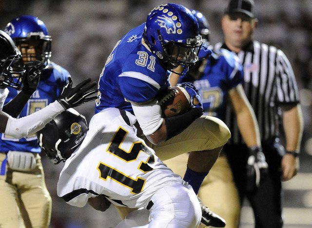 Sierra Vista running back Maliek Broady (31) runs through a tackle by Clark’s Brendon ...