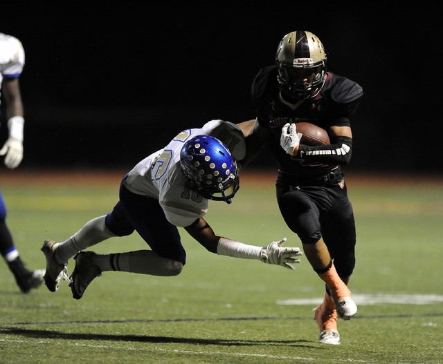 Sierra Vista safety Javion Hunt (16) goes to tackle Faith Lutheran’s Christian Marshal ...