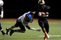 Sierra Vista safety Javion Hunt (16) goes to tackle Faith Lutheran’s Christian Marshal ...