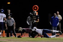 Faith Lutheran Crusaders wide receiver Mark Rubalcaba scores a touchdown despite being tackl ...