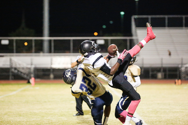 A Clark player attempts a catch but is stopped by Cheyenne’s Ashton Lawson (32) in the ...