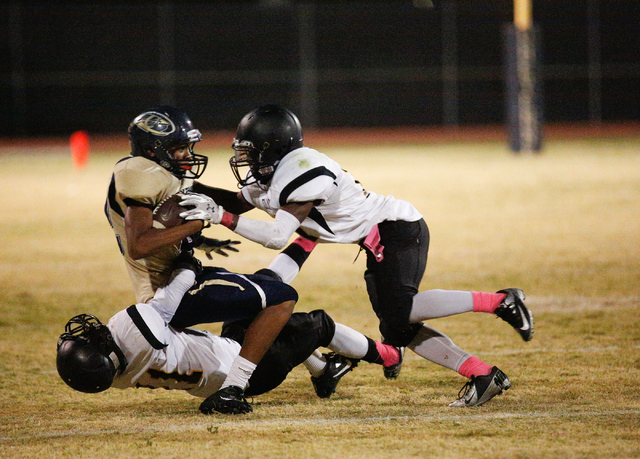 Clark’s Marquice Stuart (11) tackles Cheyenne’s Deriontae Green (3) assisted by ...