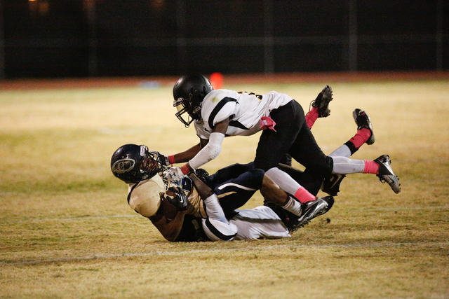 Clark’s Marquice Stuart (11) tackles Cheyenne’s Deriontae Green (3) in the secon ...