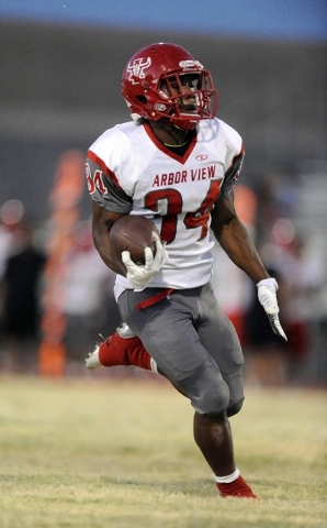 Arbor View unning back Herman Gray rushes for a first down against Silverado in the first qu ...