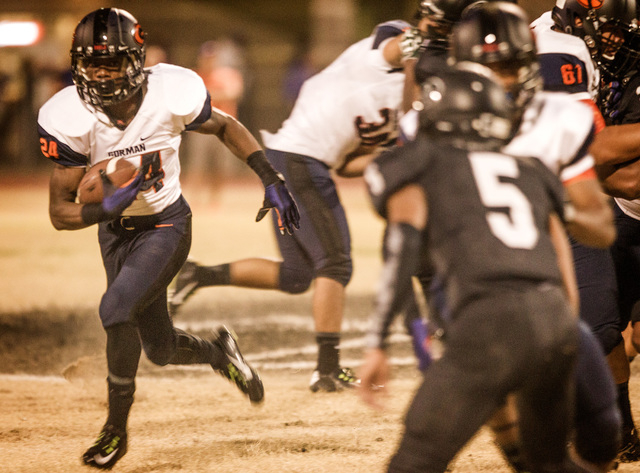 Bishop Gorman halfback Russell Booze runs to the outside against local rival Palo Verde on T ...