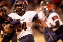 Bishop Gorman halfback Russell Booze drives to the outside to score a touchdown against loc ...