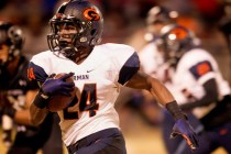 Bishop Gorman halfback Russell Booze drives to the outside to score a touchdown against riva ...