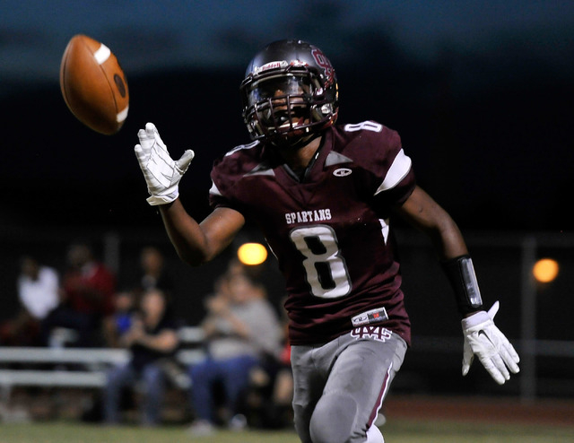 Cimarron-Memorial’s Maurice Bennett tosses the ball after scoring on a 2-point convers ...