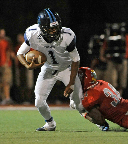 Canyon Springs quarterback Bradley Alexander (1) looks to get away from Arbor View’s H ...