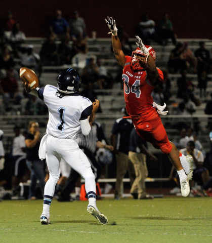 Arbor View’s Herman Gray (34) attempts to block a pass by Canyon Springs quarterback B ...
