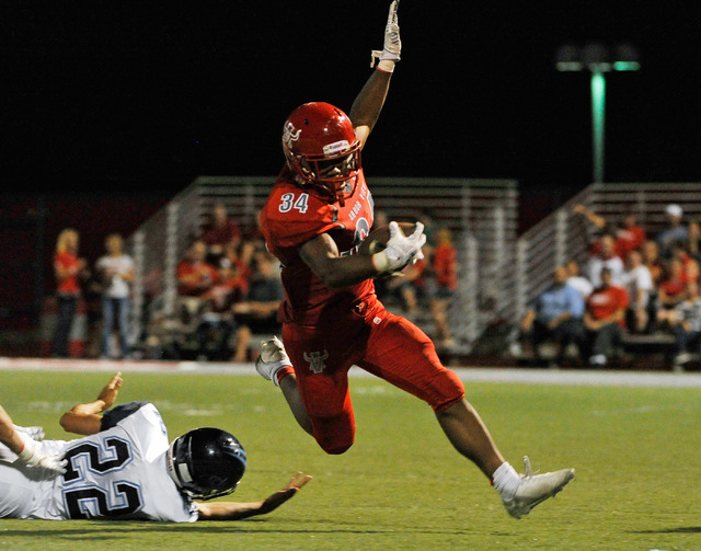 Arbor View’s Herman Gray (34) breaks free from Canyon Springs’ Kyle Stuart earli ...