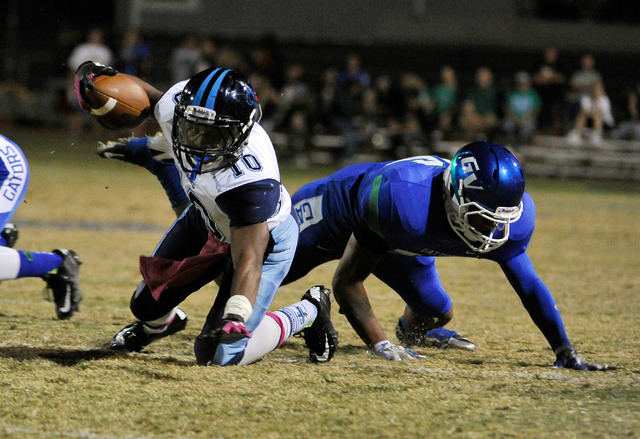 Canyon Springs’ Jerrod Blackwell (10) reaches for extra yardage against Green Valley&# ...