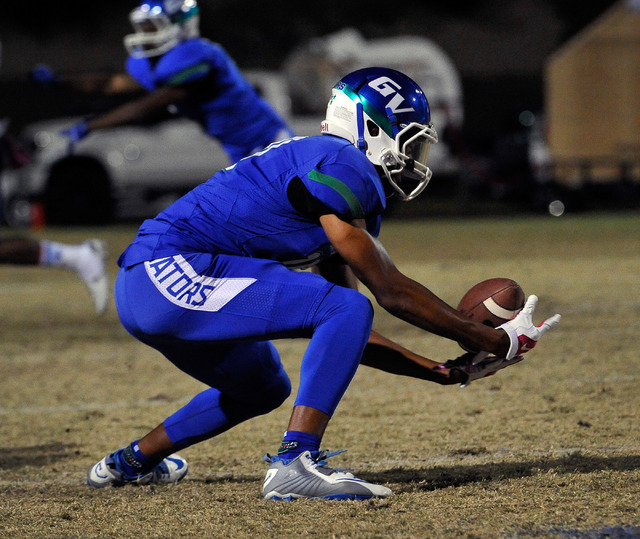 Green Valley’s Isaiah Macklin reaches to make a catch against Canyon Springs on Friday ...