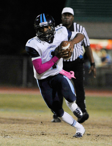 Canyon Springs quarterback Bradley Alexander runs with the ball against Green Valley on Frid ...