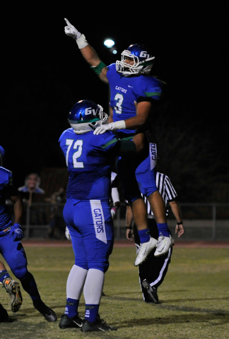 Green Valley’s Brenan Adams (3) celebrates a first-quarter touchdown with Joel Salakie ...