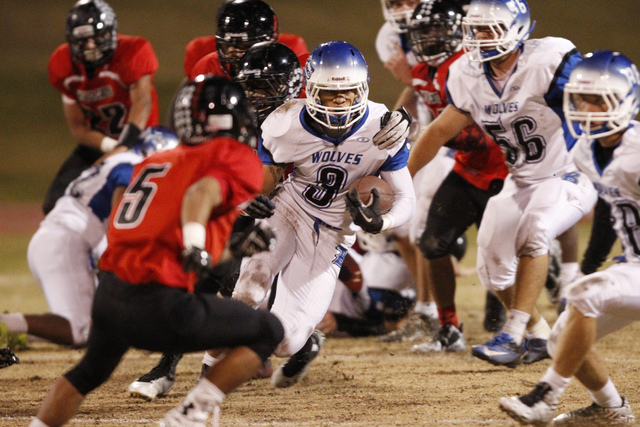 Basic’s Joshua Zachary Loveland (3) runs the ball against Las Vegas in the Division I ...