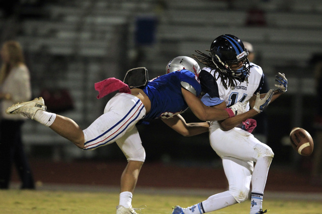 Liberty defensive back Preston Pavlica breaks up a pass intended for Canyon Springs C.J. Jon ...