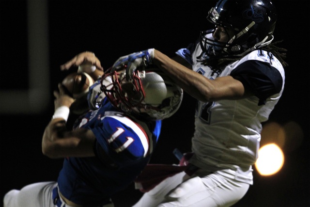 Liberty defensive back Preston Pavlica intercepts a pass intended for Canyon Springs wide re ...