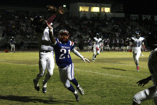 Canyon Springs Bradley Alexander breaks up a pass to Liberty wide receiver Darion Acohido on ...
