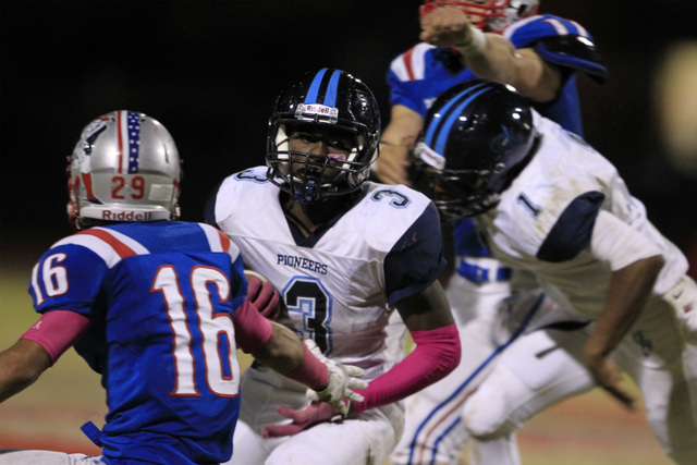 Canyon Springs running back Greg Banks looks for a path past Liberty defensive back Jake Ded ...